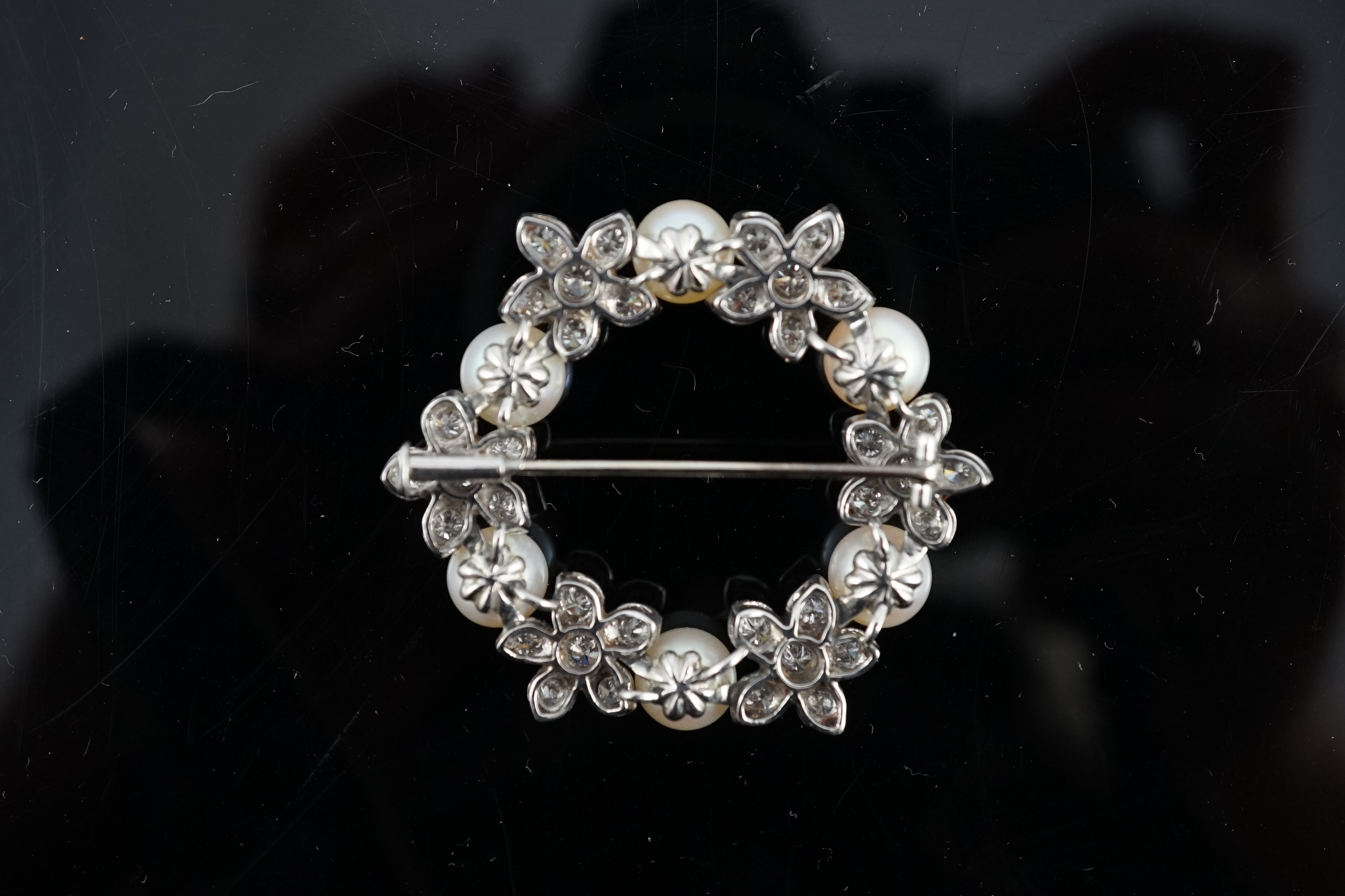A late 20th century white gold cultured pearl and diamond cluster set openwork circular brooch